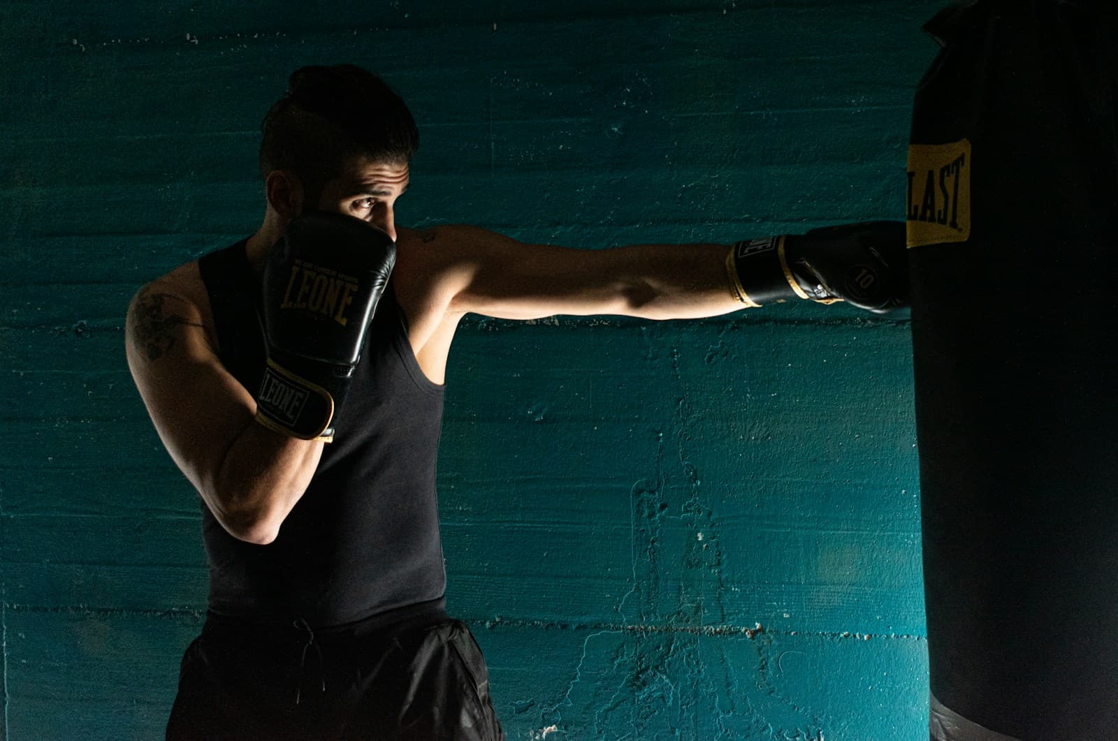 A fighter driving a straight right into the heavy bag